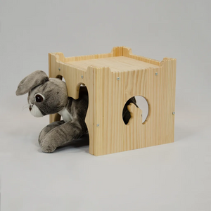 rabbit laying in a wooden house