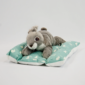 rabbit laying on green bunny snuggle bed