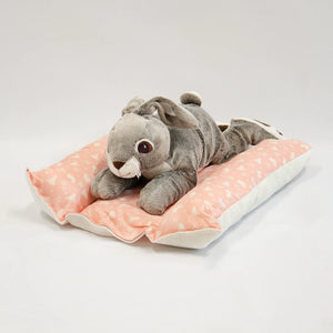 rabbit laying on pink bunny snuggle bed