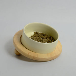 One beige bowl for rabbits on a inclined bamboo stand