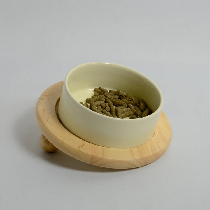 One beige bowl for rabbits on a inclined bamboo stand