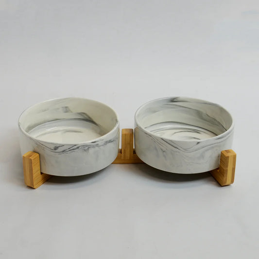 Two grey marble-look bowls on a raised bamboo stand