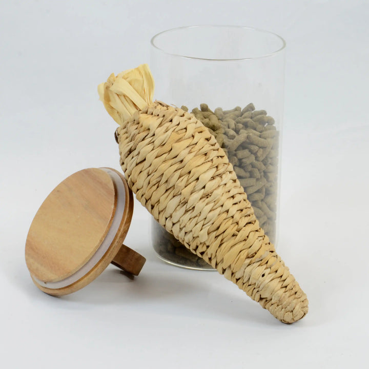 Carrot-shaped chew toy for rabbits, filled with banana leaf